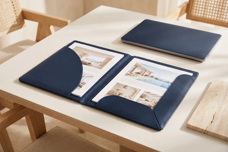 Navy leather folder with property dossiers